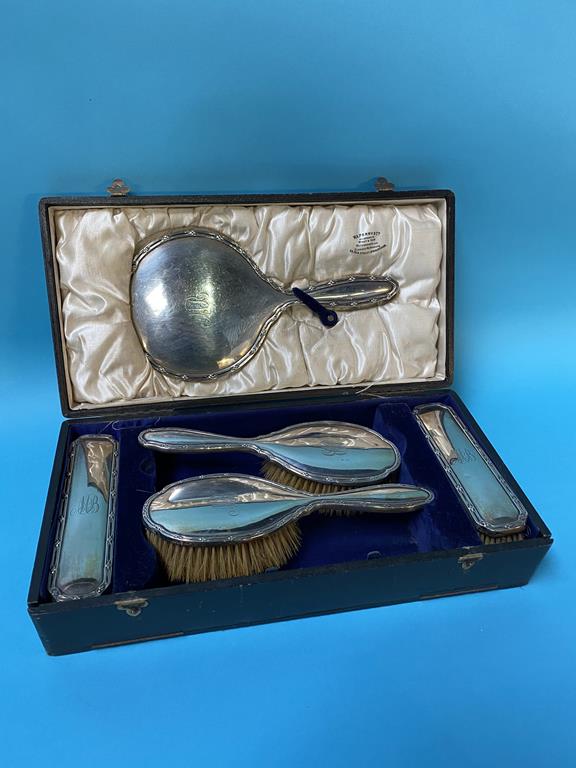 A cased five piece silver vanity set