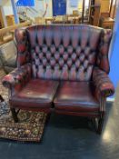 A Chesterfield oxblood two seater high back settee