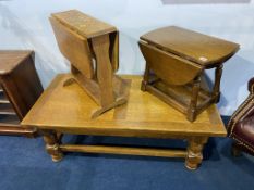 An oak coffee table and two small oak drop tables