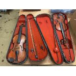 Two violins in fitted cases