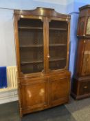 A walnut bookcase with two grilled doors, below two bowfront doors, 110cm wide