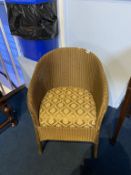 A gold Lloyd Loom chair
