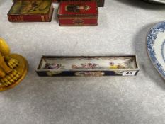 A Continental porcelain rectangular dish decorated with flowers and gilt decoration, on a blue