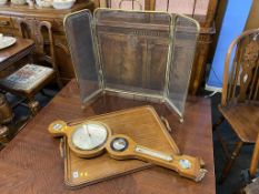 An oak two handled tea tray, barometer and a spark guard