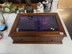 A small mahogany jewellery cabinet, with rising lid, below a short drawer, 57cm wide