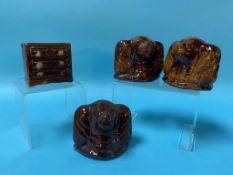 Three salt glazed Spaniel head money boxes and a miniature chest of drawers