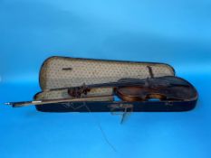 A violin in coffin case, labelled 'Copy of Giovan Paolo Maggini' and a bow