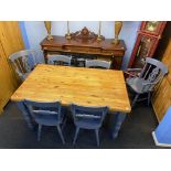 A pine kitchen table with six grey painted chairs