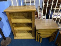 A pine bookcase and nest of tables