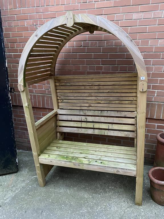 A pine garden Arbour with attached bench