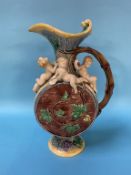 A Minton Majolica wine ewer, decorated with putti, grapes and vine leaves, impressed marks, 37cm