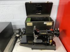 A Singer 222k sewing machine and case