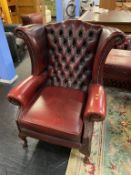A Queen Anne leather wing armchair
