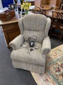 An as new electric rise and recliner armchair