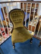 A Victorian walnut button back nursing chair