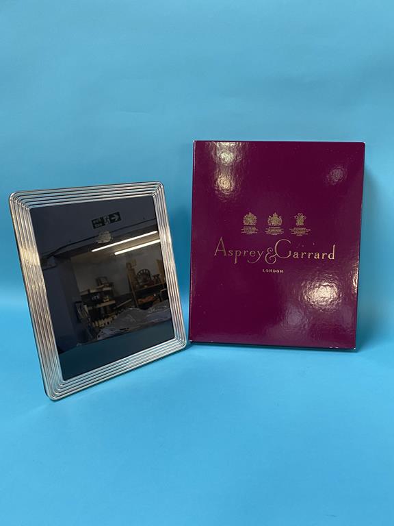 A boxed Asprey and Garrard silver photo frame