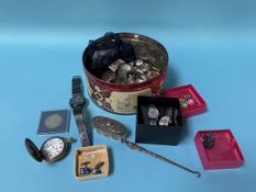 A tin of assorted wristwatches and coins etc.