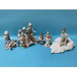 Three Lladro figures and four Nao figures