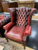 An oxblood Chesterfield high back armchair