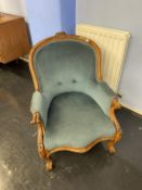 A Victorian walnut serpentine front armchair