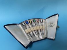 A cased set of six enamelled silver cocktail sticks
