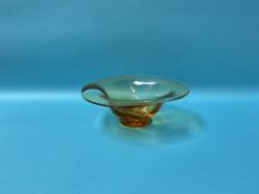 An amber coloured glass circular bowl