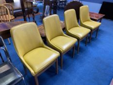 A set of four teak and vinyl chairs