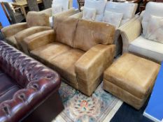 A tan leather sofa, armchair and footstool