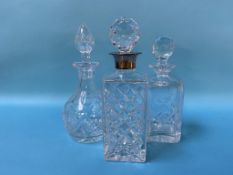 A silver rimmed decanter and two others (3)
