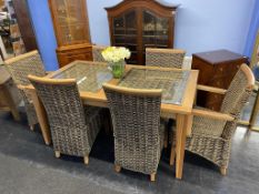 A teak and wicker table and six chairs