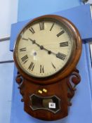 A mahogany circular drop dial wall clock