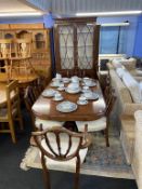 A reproduction mahogany eight piece dining room suite, display cabinet and extendable table and