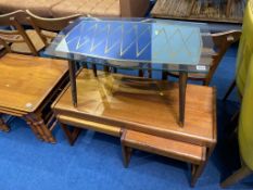 A teak nest of tables and a glass top occasional table
