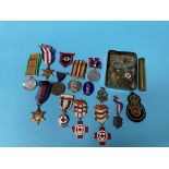 A collection of various cap and shoulder badges, patches and various medals etc.