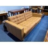 A tan leather two seater sofa