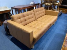 A tan leather two seater sofa