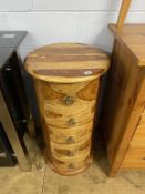 A modern hardwood round chest of drawers