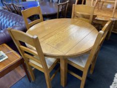 An oak extending table and four chairs
