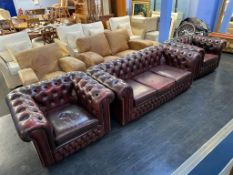 A leather oxblood Chesterfield three piece suite