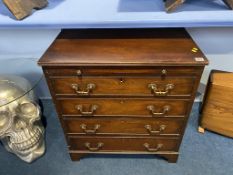 A mahogany straight front chest of drawers with brushing slide