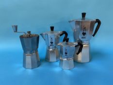 Three Bialetti coffee makers and a coffee grinder