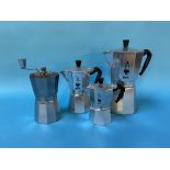 Three Bialetti coffee makers and a coffee grinder