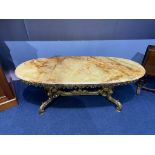 An onyx and heavy brass oval coffee table