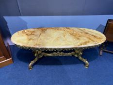 An onyx and heavy brass oval coffee table