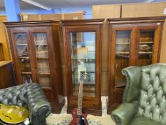 A pair of display cabinets and a matching cabinet