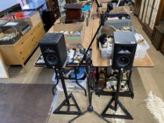 A pair of JBL speakers and stands and a mic stand