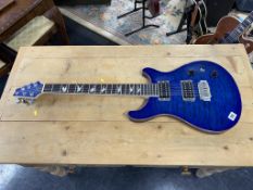 An electric blue guitar, serial number YAHC0556
