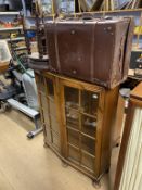 A piano stool, suitcase and china cabinet
