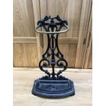 A cast iron and brass stick stand