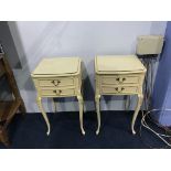 A pair of cream bedside drawers